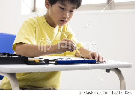 Children doing calligraphy Children doing calligraphy 127181082