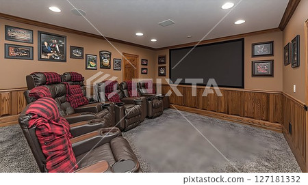 Cozy home theater with leather recliners, plaid throws, and spor 127181332