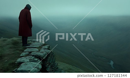 Solitary Figure in Red Coat Contemplates Misty Landscape Over Ro 127181344