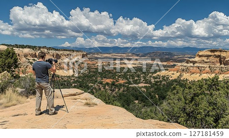 Photographer Capturing Expansive Desert Vista Under Dramatic Clo 127181459