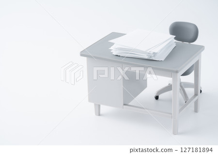 Piles of papers on a desk in a miniature office Piles of papers on a desk in a miniature office 127181894