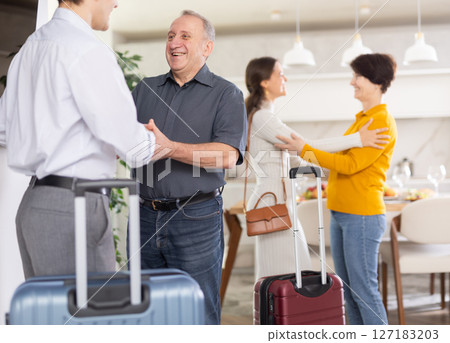 Parents joyfully welcome their adult children who have come to visit from far away Parents joyfully welcome their adult children who have come to visit from far away 127183203