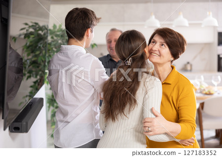 Happy parents welcome their adult son and daughter-in-law at home 127183352