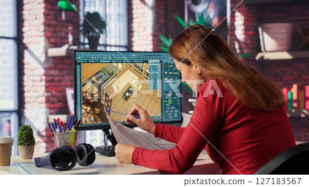 Remote worker in creative office uses CAD software and blueprints plan, design a house interior and provides a user interface for virtual home customization. Detailed architectural layout. Camera A. Remote worker in creative office uses CAD software and blueprints plan, design a house interior and provides a user interface for virtual home customization. Detailed architectural layout. Camera A. 127183567