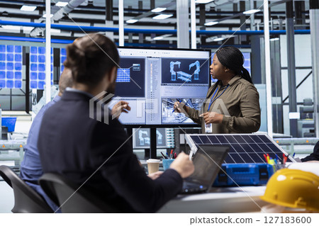 Shareholders collaborate on renewable energy investments, looking at data on display. Photovoltaics facility management team looking at manufacturing equipment specs on monitor, doing brainstorming Shareholders collaborate on renewable energy investments, looking at data on display. Photovoltaics facility management team looking at manufacturing equipment specs on monitor, doing brainstorming 127183600
