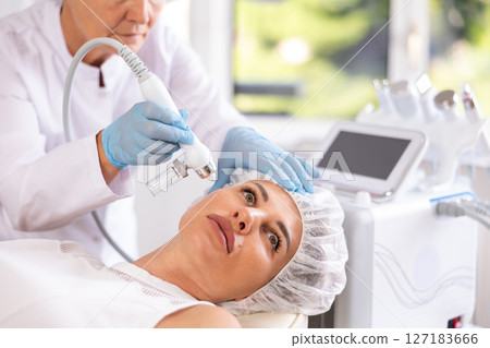 RF lifting and deep hydration for facial skin on young woman in clinic 127183666