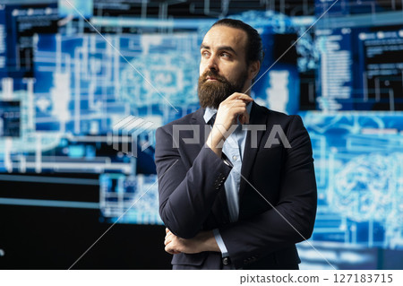 Young businessman studies artificial intelligence neural network on dashboards, using high tech automation tools for coding, analytics and machine learning for strategic development. 127183715