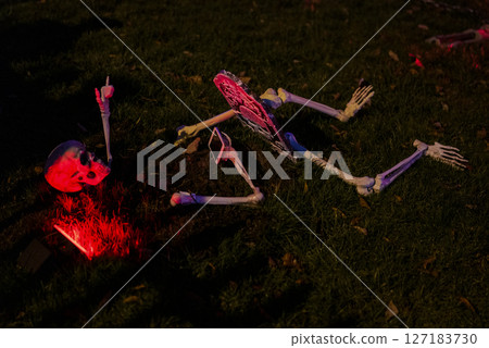 Creepy Skeleton Scene with Pink Lighting in Spooky Halloween Display 127183730