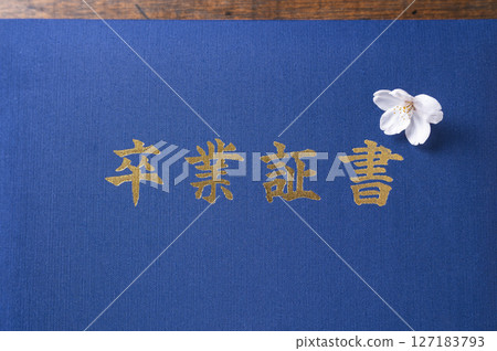 Diploma and cherry blossom petals 127183793