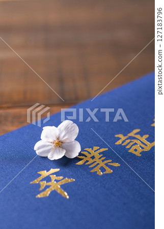 Diploma and cherry blossom petals 127183796