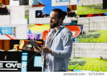 Male cool influencer hosting a live presentation with hands free microphone, engaging an audience to discuss social media reach, digital interaction and creative branding in real time. Trend setter. Male cool influencer hosting a live presentation with hands free microphone, engaging an audience to discuss social media reach, digital interaction and creative branding in real time. Trend setter. 127183804