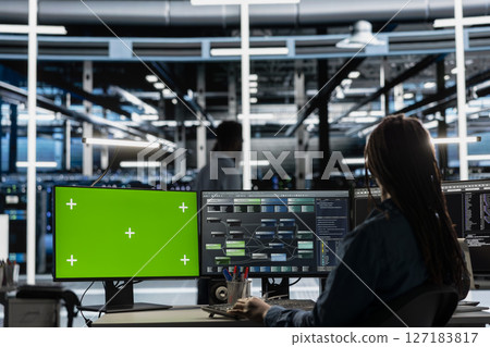 Developer in data center at green screen PC uses AI for machine learning workloads. IT specialist in server hub uses artificial intelligence on chroma key computer to perform demanding computing tasks 127183817