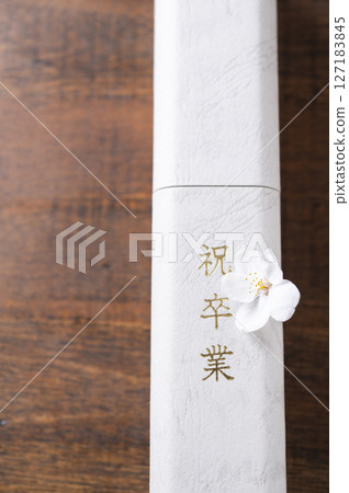 Diploma and cherry blossom petals Diploma and cherry blossom petals 127183845