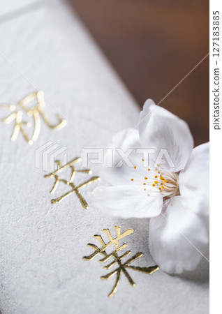 Diploma and cherry blossom petals Diploma and cherry blossom petals 127183885