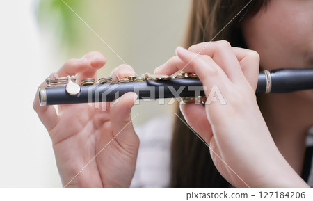 Young woman playing the piccolo 127184206