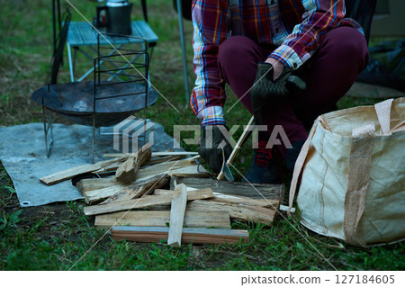 Solo camper cutting firewood, Solo camping, Senior Solo camper cutting firewood, Solo camping, Senior 127184605