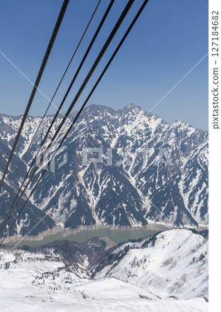 A beautiful winter view of Kurobe Dam and the majestic snow-covered mountains seen from near Kurobedaira Station on the Tateyama Ropeway A beautiful winter view of Kurobe Dam and the majestic snow-covered mountains seen from near Kurobedaira Station on the Tateyama Ropeway 127184682