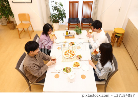 Men and women around the dining table 127184887