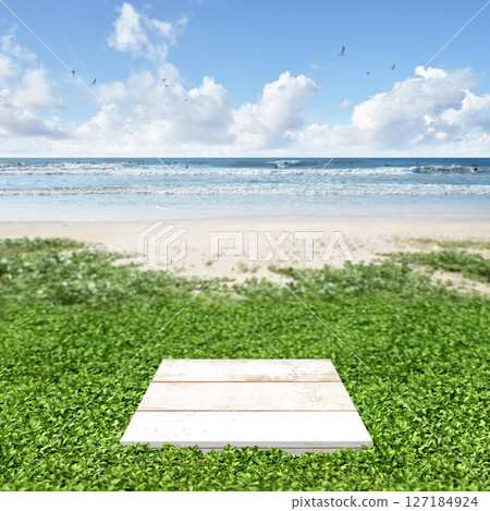 A fantasy summer landscape with a sandy beach leading to the sea, blue skies, and display stands 127184924