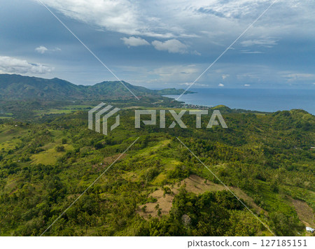 Tropical mountain with forest and green vegetation. Blue sky and clouds. Mindanao, Philippines. Tropical mountain with forest and green vegetation. Blue sky and clouds. Mindanao, Philippines. 127185151