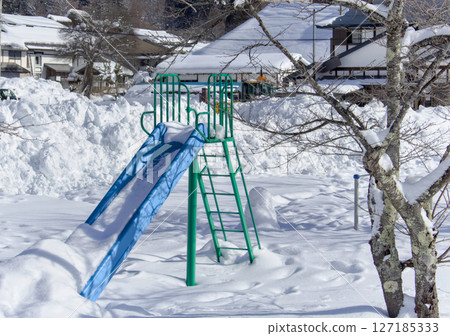 A beautiful slide covered in blue and green snow A beautiful slide covered in blue and green snow 127185333