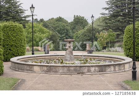 A water fountain within Alexandra Palace Gardens. it's located within the Formal Rose Garden. 127185638