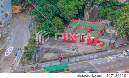 June 6 2025 Traditional Red Temple by Street with Lush Green Trees 127186228