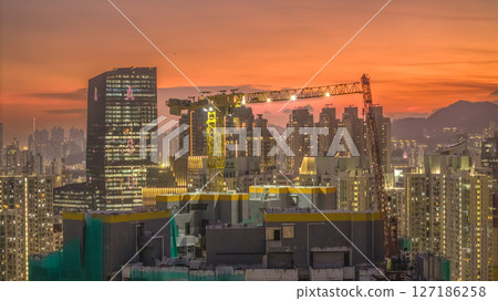 June 6 2025 Urban Cityscape with Vibrant Sunset and Construction Cranes 127186258