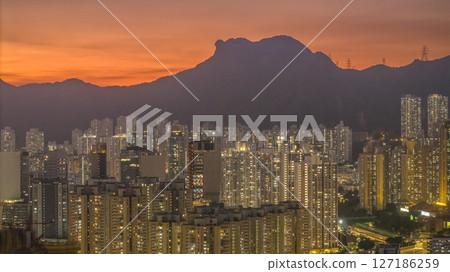 June 6 2025 Cityscape at Sunset with Mountain Silhouette and Illuminated 127186259