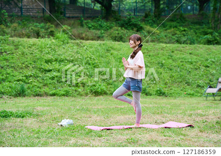 Yoga exercise stretching outdoor park middle-aged senior 127186359