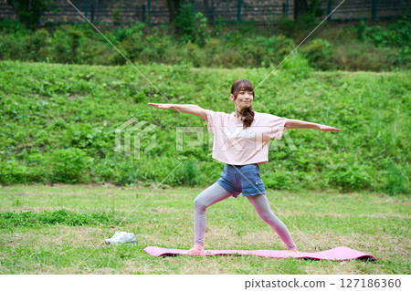 Yoga exercise stretching outdoor park middle-aged senior 127186360