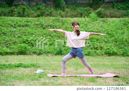Yoga exercise stretching outdoor park middle-aged senior 127186361