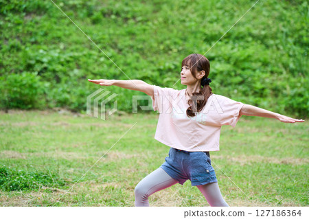 Yoga exercise stretching outdoor park middle-aged senior 127186364