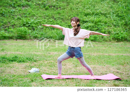 Yoga exercise stretching outdoor park middle-aged senior 127186365