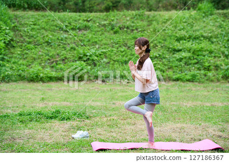 Yoga exercise stretching outdoor park middle-aged senior Yoga exercise stretching outdoor park middle-aged senior 127186367