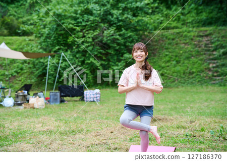 Yoga exercise stretching outdoor park middle-aged senior 127186370