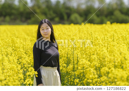 一名女子在盛開的油菜花田中觀光 127186822