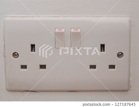 Double UK Electrical Wall Socket with Switches Turned On Double UK Electrical Wall Socket with Switches Turned On 127187645