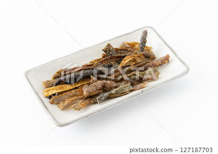 Salmon skin chips on a plate on a white background Salmon skin chips on a plate on a white background 127187703