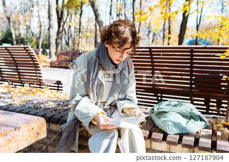 portrait teenage student with notepad in hands in an autumn park portrait teenage student with notepad in hands in an autumn park 127187904