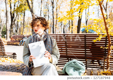 portrait teenage student with notepad in hands in an autumn park 127187948