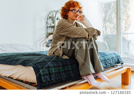 Teen girl with broken arm, wearing glasses, red hair, in bedroom Teen girl with broken arm, wearing glasses, red hair, in bedroom 127188185