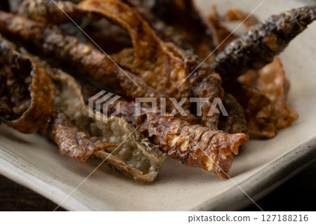 Salmon skin chips on a plate Salmon skin chips on a plate 127188216