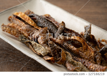 Salmon skin chips on a plate Salmon skin chips on a plate 127188219