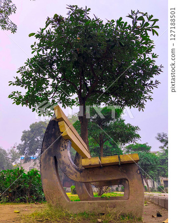 Park Bench Under a Lush Green Tree Nature Photography Park Bench Under a Lush Green Tree Nature Photography 127188501