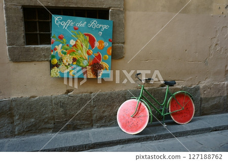 Colorful bicycles and signs in a Florence backstreet 127188762