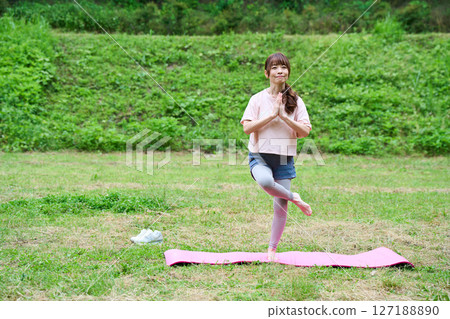 Yoga exercise stretching outdoor park middle-aged senior 127188890