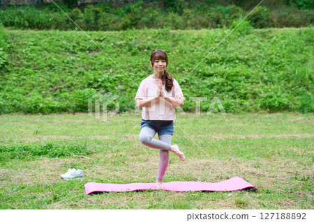 Yoga exercise stretching outdoor park middle-aged senior 127188892