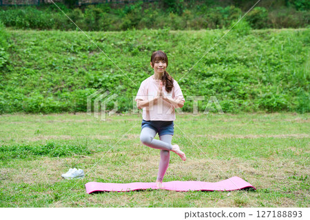 Yoga exercise stretching outdoor park middle-aged senior 127188893