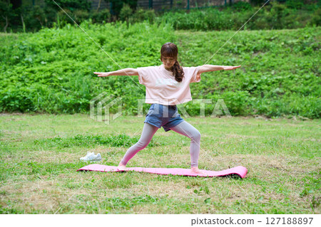 Yoga exercise stretching outdoor park middle-aged senior 127188897
